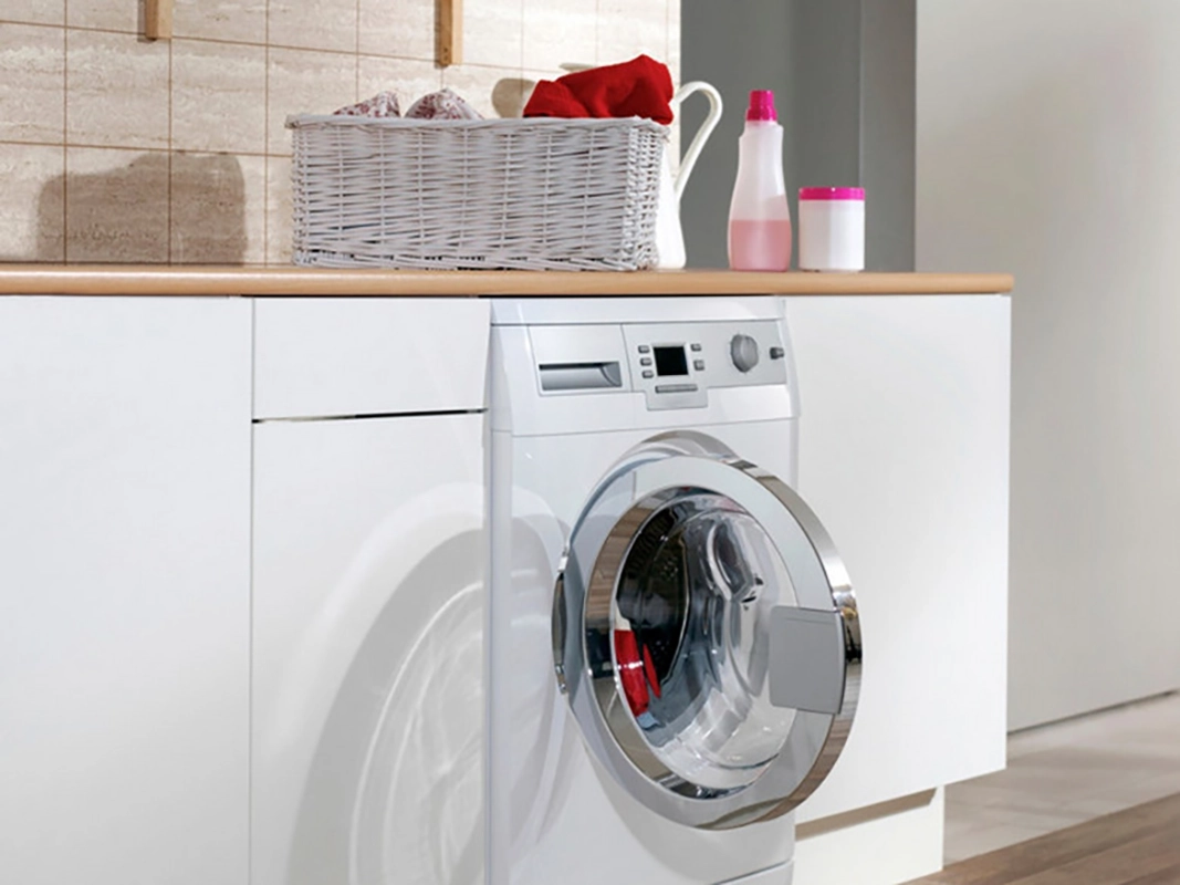 A modern front-loading washing machine displaying various technical features and cycle settings to help users understand appliance performance.