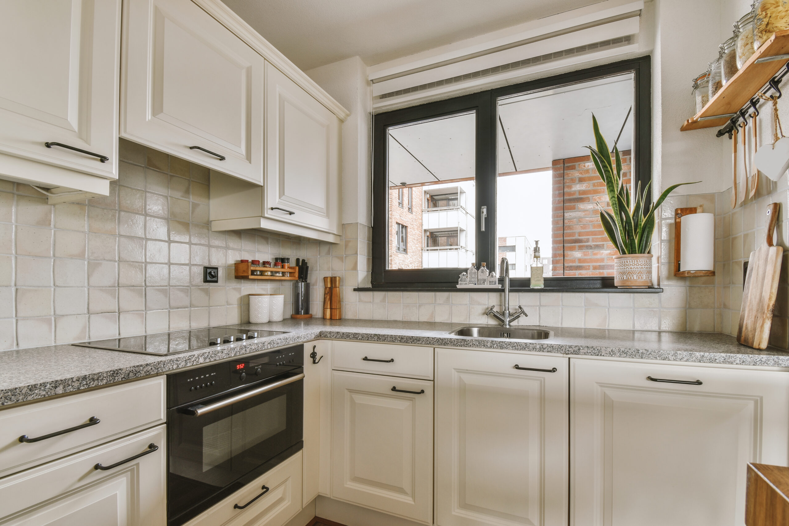 Professional engineer performing an electric cooker repairing service on a modern kitchen appliance to fix a faulty heating element.