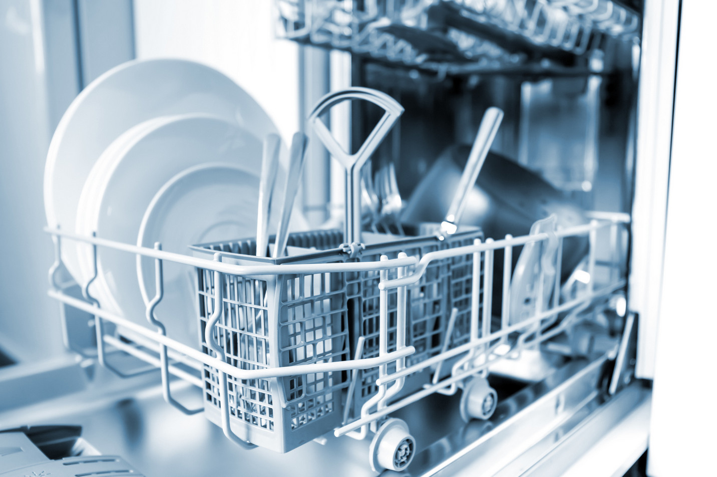 A professional engineer assessing a faulty appliance to determine if you should repair or replace your dishwasher for better energy efficiency.