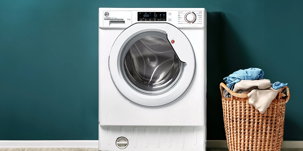 A front view of the Hoover HBWOS-69TAMSE integrated washing machine featuring a 9kg drum, 1600 spin speed, and a sleek white finish for modern kitchens.