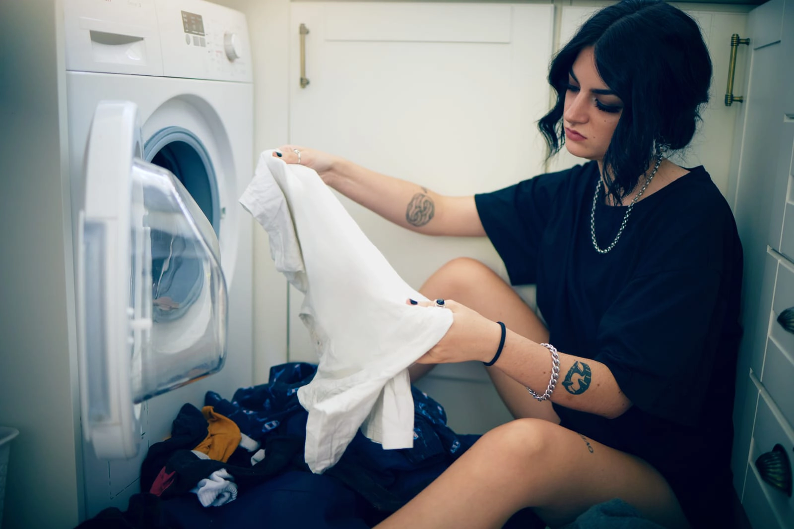 Suggested for a high-quality image showing neatly folded clothes or a person carefully checking a garment label