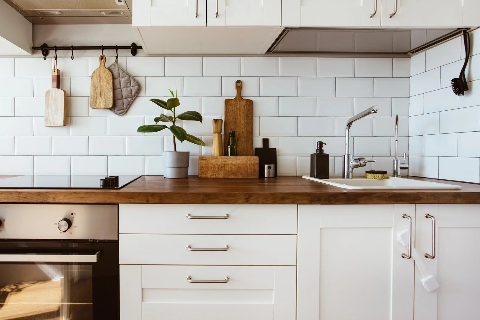 An Integrated Oven Specialist performing an Integrated Appliance Repair and a Built-in Dishwasher Repair in a fitted kitchen