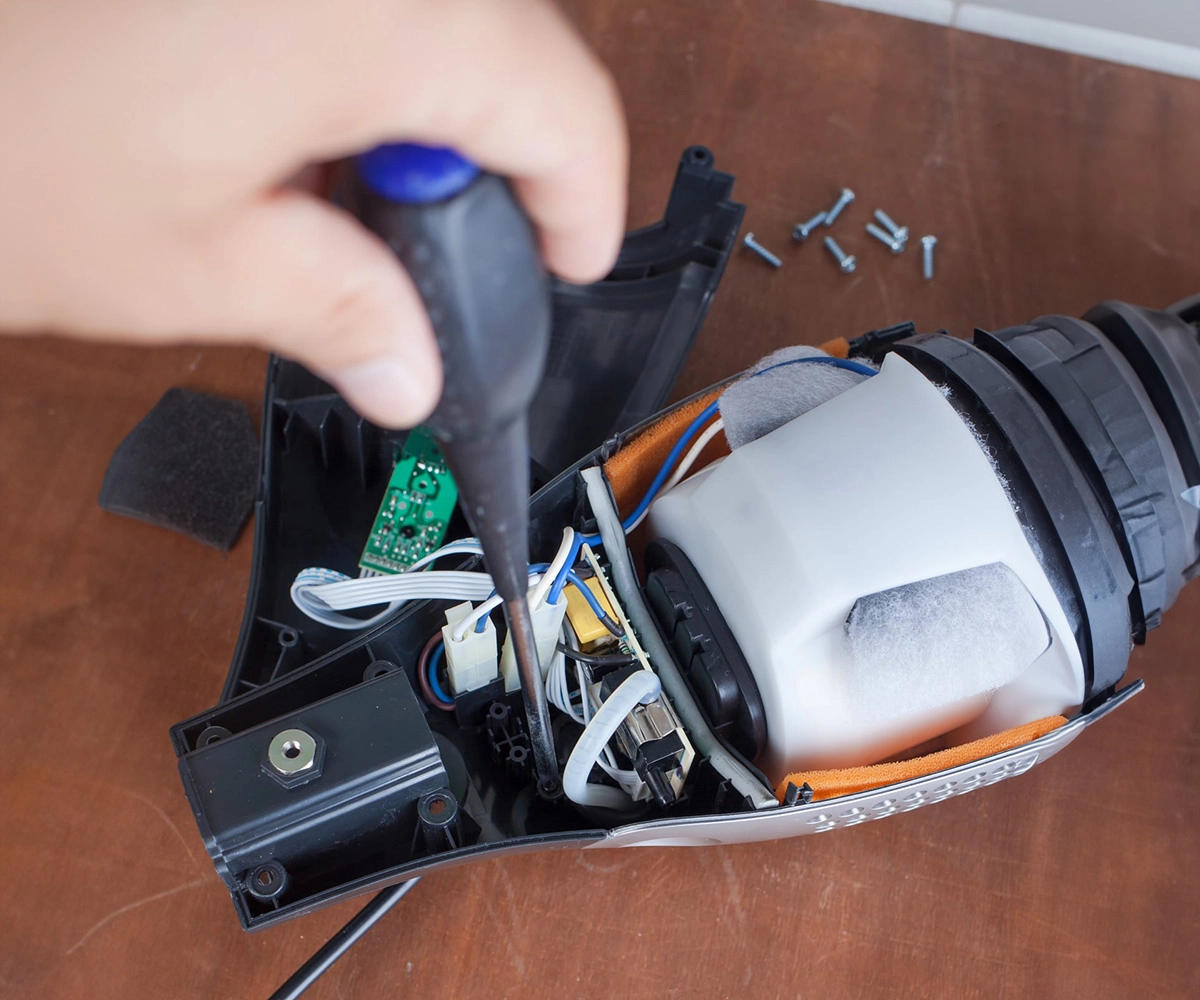 A technician performing a Professional Vacuum Service to fix a Dyson Losing Suction and carrying out a detailed Dyson Vacuum Repair