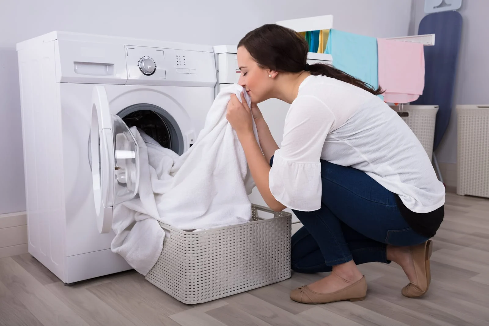 76660080_woman-smelling-cloth-after-washing-in-washing-machine - Appliance Repair Men - Appliance Repair Men Washing Machine