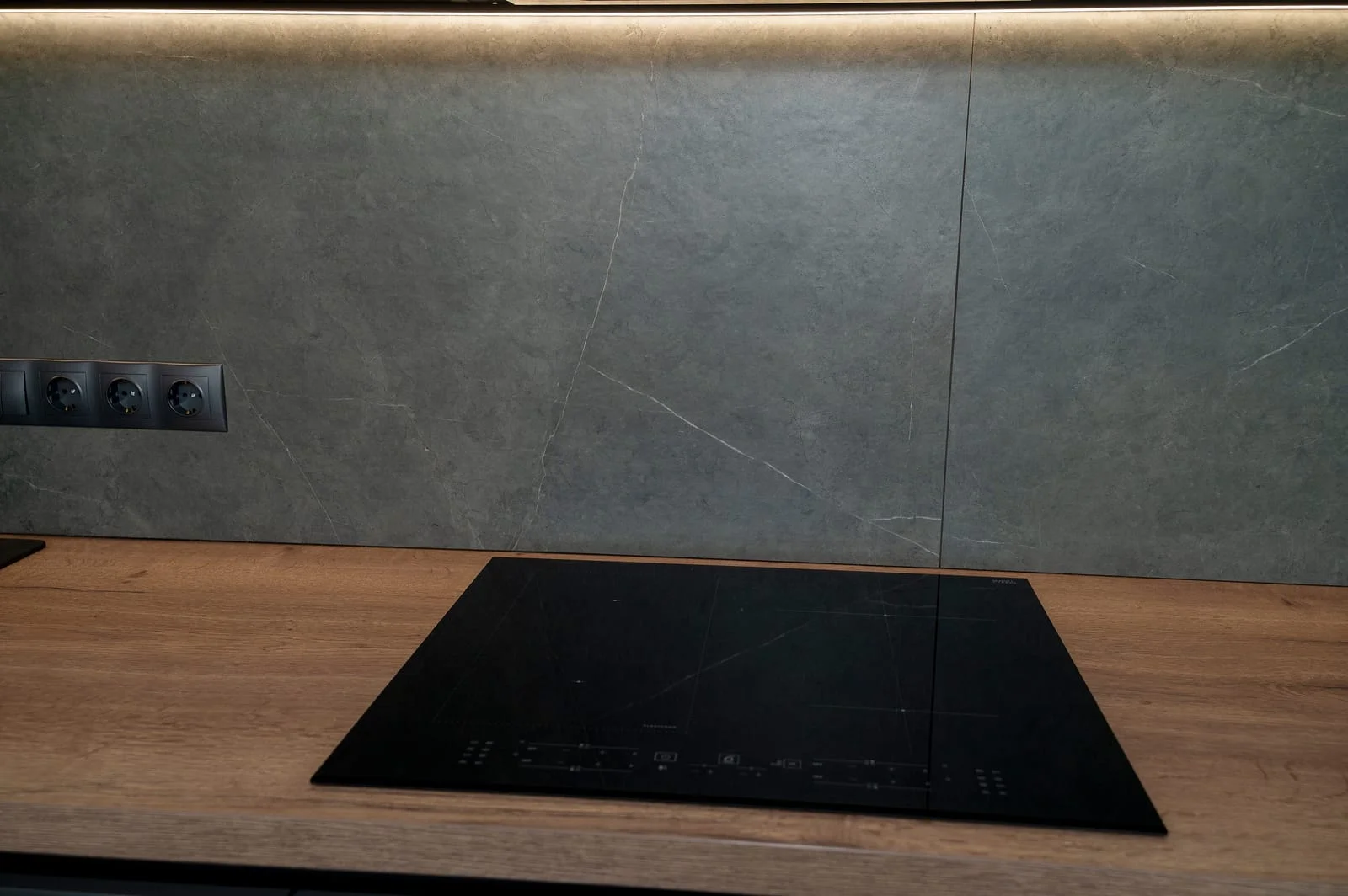 98021416_built-in-black-induction-hob-on-wooden-tabletop - Appliance Repair Men - Appliance Repair Men