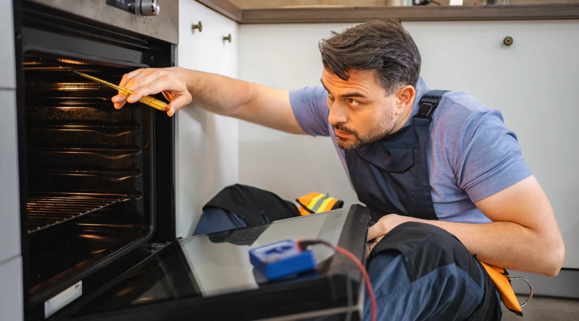Fan Oven Element Faults and Why the Fan Runs With No Heat - Appliance Repair Men Engineer testing the fan oven element behind the back panel of an electric oven in a West Lancashire kitchen with a multimeter